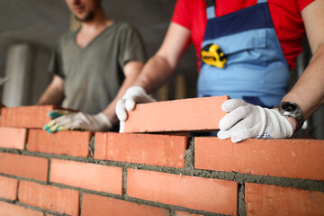 Bricklayers st construction site laying bricks
