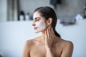 Woman using a cream for her skicare routine