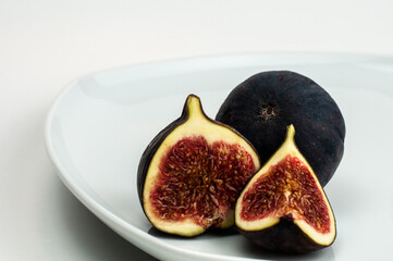cut fig fruits on a white plate