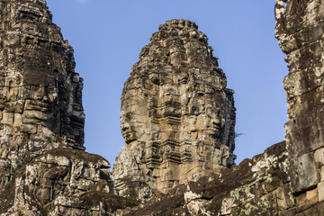 serene and smiling stone faces on towers of Bayon Temple, Angkor, Cambodia