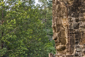 serene and smiling stone faces on towers of Bayon Temple, Angkor, Cambodia