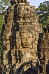 Fototapeta premium serene and smiling stone faces on towers of Bayon Temple, Angkor, Cambodia