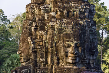 serene and smiling stone faces on towers of Bayon Temple, Angkor, Cambodia