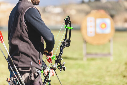 Professional Male Archer Loading an Arrow on the Bow