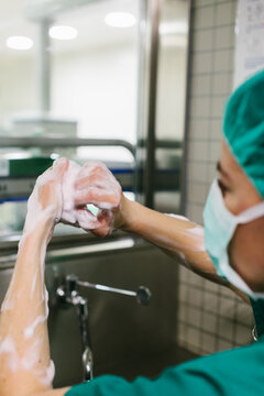 Couple of Surgeons Washing Hands Before Operating