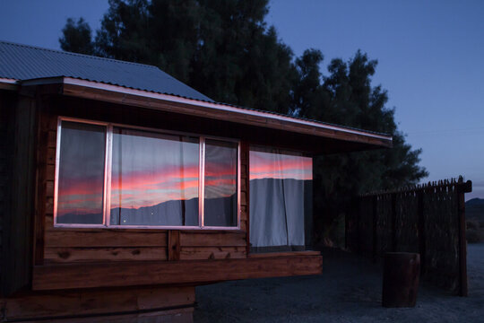 Fototapeta Reflection of Sunset on Cabin Windows
