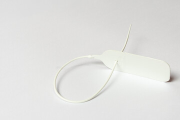 White plastic seal for identification, lock and protection on white background.