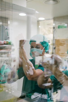Couple of Surgeons Washing Hands Before Operating