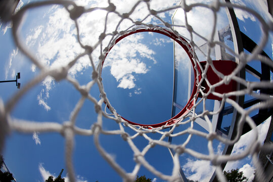 Looking Up Through Basketball Net At Blue Sky