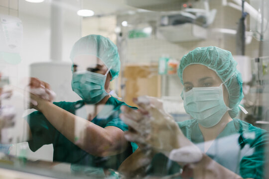Couple of Surgeons Washing Hands Before Operating