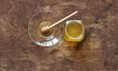Obraz na płótnie Canvas The idea of natural products. On a wooden natural ancient background honey and a spoon with honey.