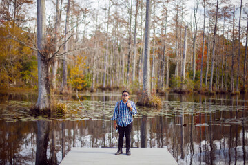 Attractive Hispanic Man Standing On A Swamp Boat Launch Pad