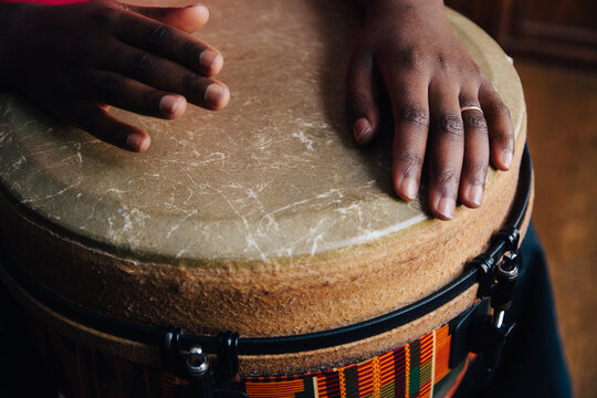 Black girl's hands playing a djembe drum