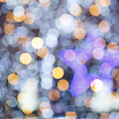 Abstract night holiday background with defocused Christmas illumination and bokeh star