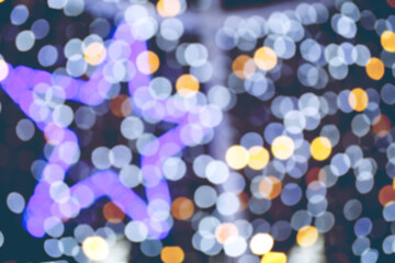 Abstract night holiday background with defocused Christmas illumination and bokeh star