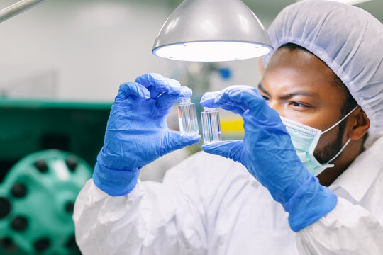 African american male engineer doing quality control checks in a factory.
