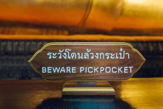 Beware Pickpocket"" Sign in Buddhist Temple in Bangkok