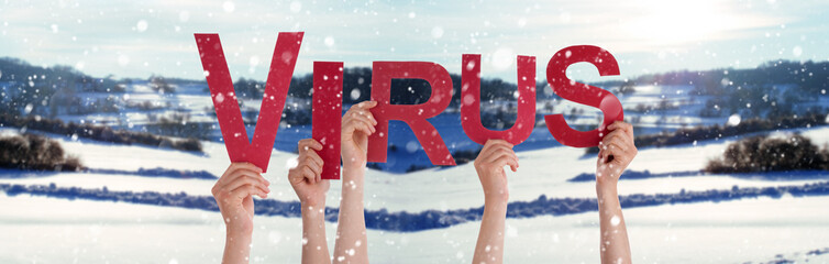 People Hands Holding Red English Word Virus. Snowy Winter Background With Snowflakes