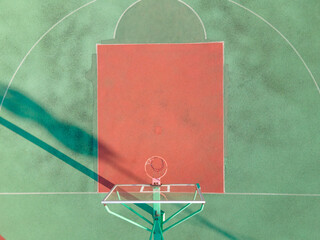Drone aerial view of the basketball field half court basketball stands hoop. Green basketball court and hoop in the sunny day. Quite no people view of sports calm city lift concept Shanghai China