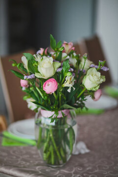 Simple mixed pastel flowers in glass vase on the table