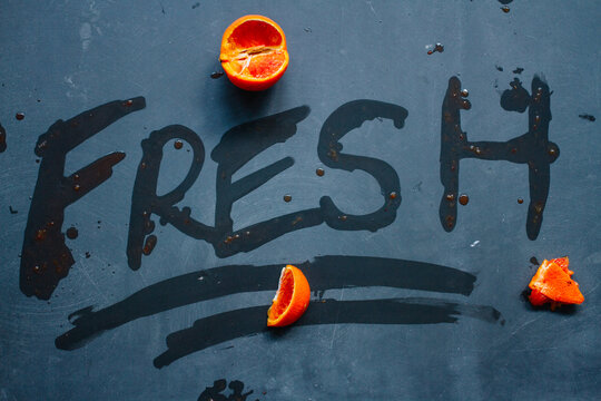 Fresh hand lettering on slate in fruit juices