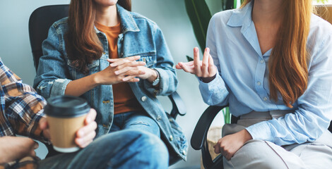 A group of young people sitting and talking together