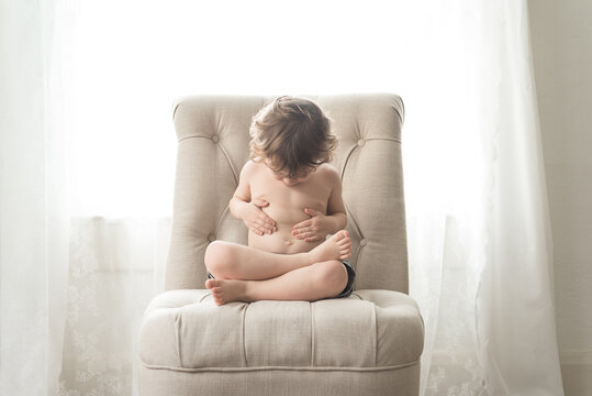 A Little Boy Looks At His Belly Button