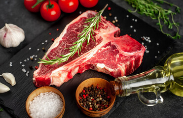 raw t-bone steak with ingredients  on stone background