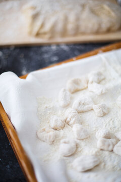 Close up of homemade potato gnocchi on covered in flour tray