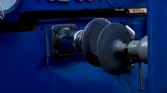 Standard type of connection between cars train on railways with buffer and chain coupling. Traditional hook coupler wagon hitch. Connecting coupling device between railway cars on train at rail track