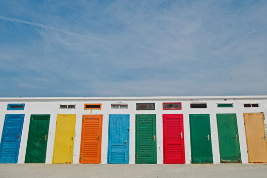 Colorful doors on the beach with blue sky above