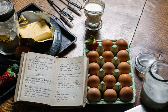 Recipe book with a genoise sponge recipe on open page and ingredients on table.
