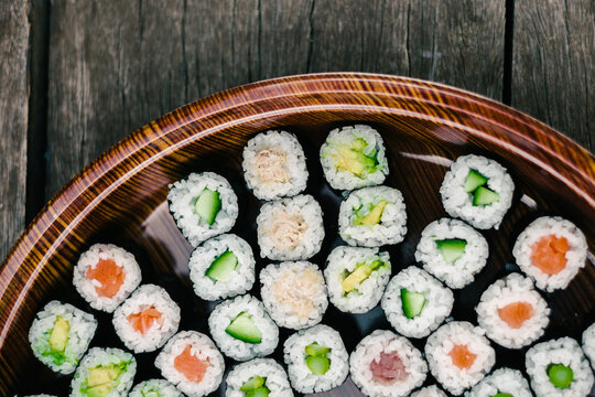horizontal image of sushi rolls on a platter