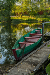 wooden boat stands near the river bank