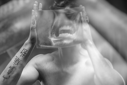 scream, guy with tattoos and a magnifying glass screaming