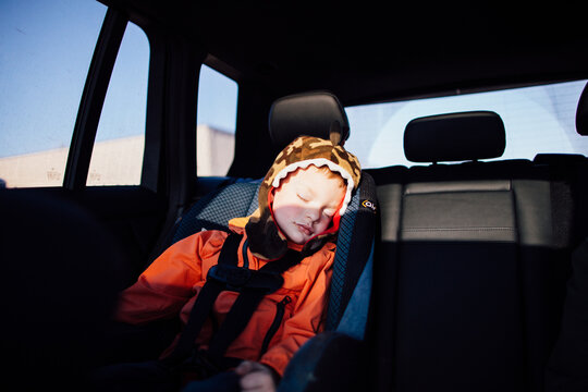 A little guy sleeping in the car