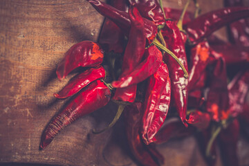 Dry Red Hot Chili Peppers over wooden background