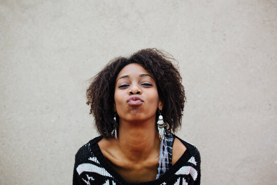 Facial expression of a young african woman: kissing