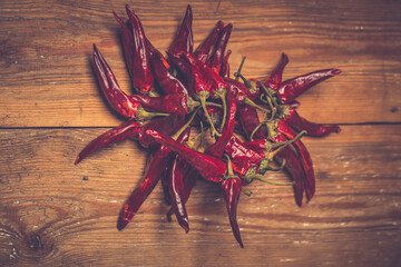 Dry Red Hot Chili Peppers over wooden background