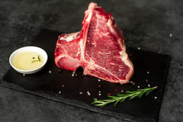 raw t-bone steak on  stone background