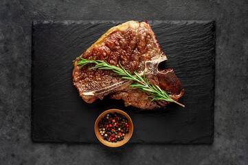 grill t-bone steak with ingredients on stone background