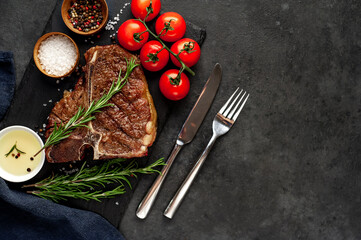 grill t-bone steak with ingredients on  stone background with copy space for your text