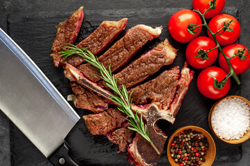 grill t-bone steak with ingredients on stone background