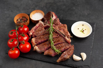grill t-bone steak with ingredients on stone background