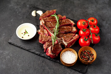 grill t-bone steak with ingredients on stone background