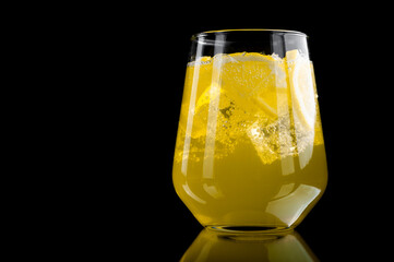  refreshing lemonade with lemon slices and ice cubes on black background