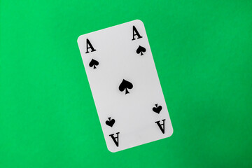 ace of spades on green background