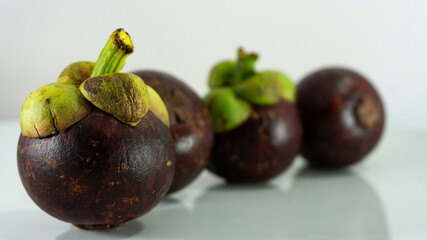 Sweet mangosteen and delicious, Asian fruits on a white background.                        
