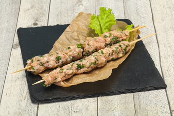 Raw minced pork skewer kebab for grill