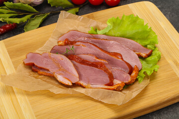 Sliced smoked duck breast served salad